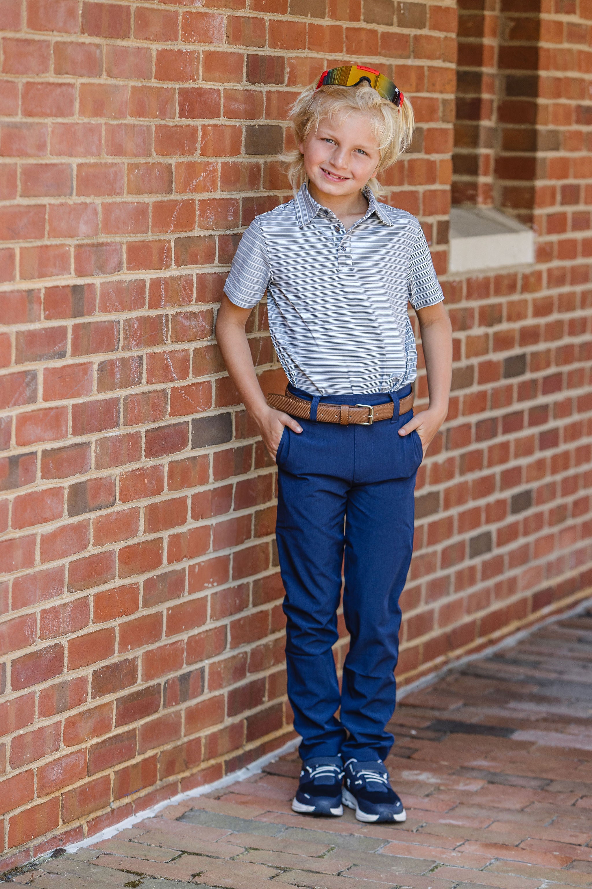Young boy wearing striped polo and navy pants Model is 10yrs 80lbs